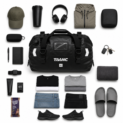 Collection of travel items including a black duffel bag, clothing, and accessories - Taanc tail bag terra series
